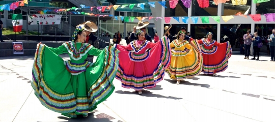 Latina dancers dancing on SF State campus quad open space